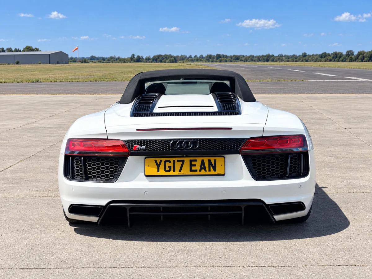 Rear view of the Audi R8 Spyder with the roof up, diffuser and twin exhausts